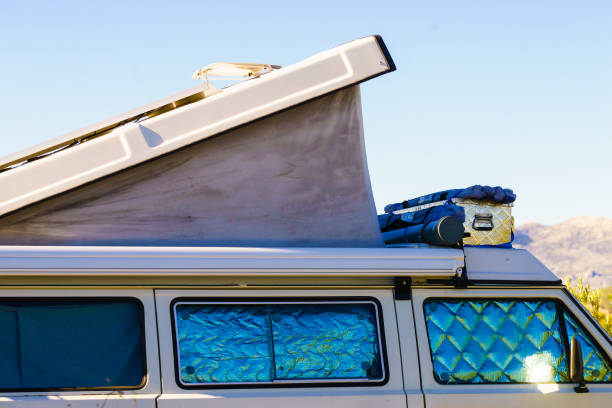 istock Camper van with roof top tent camp on nature 2170579281