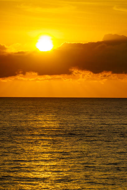 Seascape. Sunrise over sea water. Sun rising above horizon.