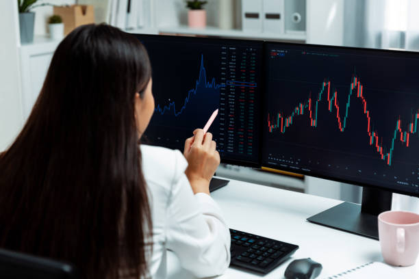 istock Young Asian pointing with pen to exchange stock on pc screen. Stratagem. 2170581500