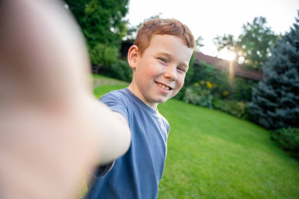 istock Joyful redhead boy making selfie at the backyard at sunset 2170581506