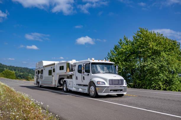 istock Specialized low profile four doors extended cab white big rig semi truck tractor transporting mobile semi trailer for carry and transporting horses running on the highway road in Columbia Gorge area 2170582253