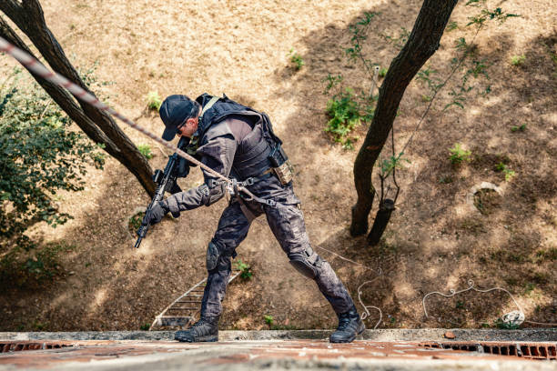 istock Special forces operative skilfully descending rope in military training 2170585456