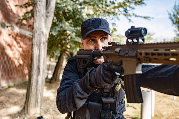 istock Single armed soldier tactical move beside brick building in military training 2170585626