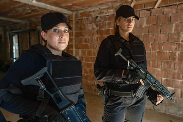 istock Two armed female soldiers taking a break inside brick building in military training 2170585774