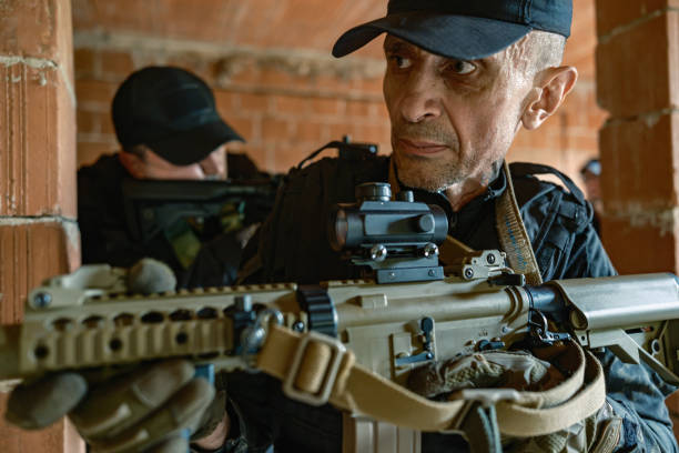 istock Two armed soldiers tactical move inside brick building in military training 2170585782