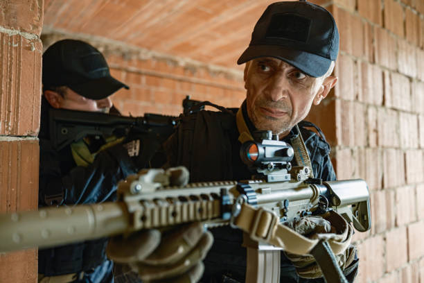 istock Two armed soldiers tactical move inside brick building in military training 2170585786