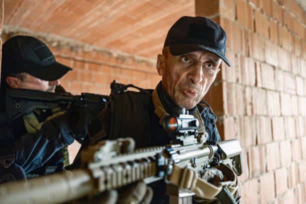 istock Two armed soldiers tactical move inside brick building in military training 2170585791