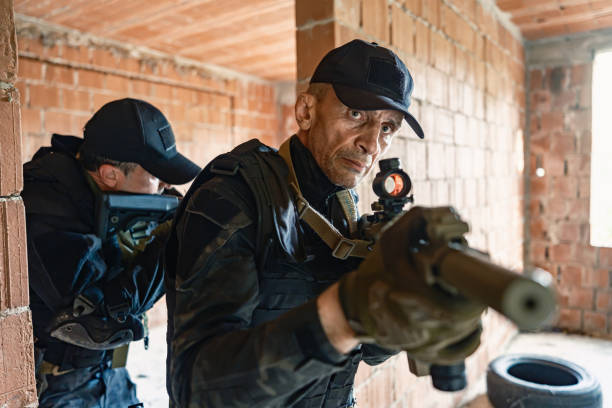 istock Two armed soldiers tactical move inside brick building in military training 2170585793