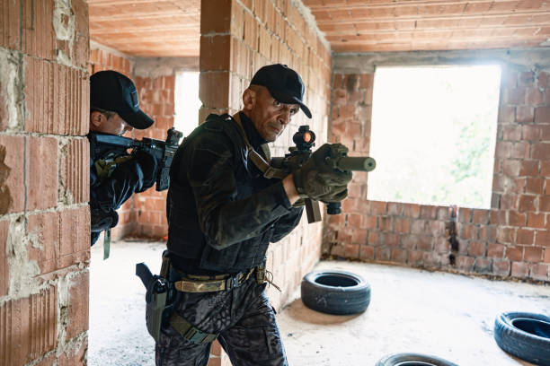 istock Two armed soldiers tactical move inside brick building in military training 2170585794