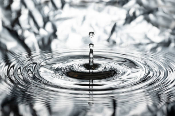 istock a drop of water jumps up from the water surface 2170588449