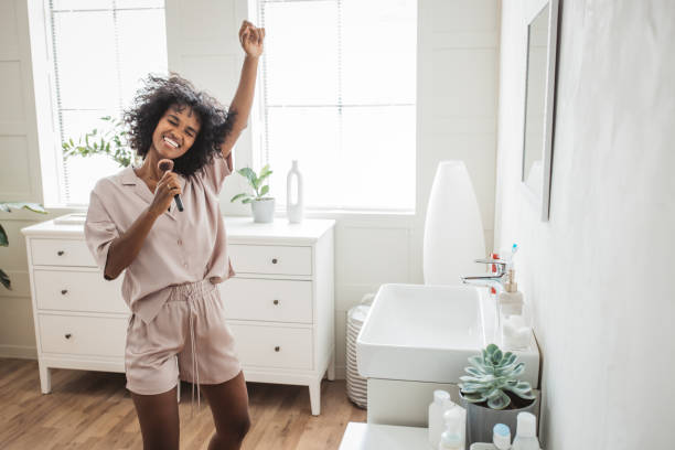 istock Smiling woman brushing teeth in bathroom 2170589364