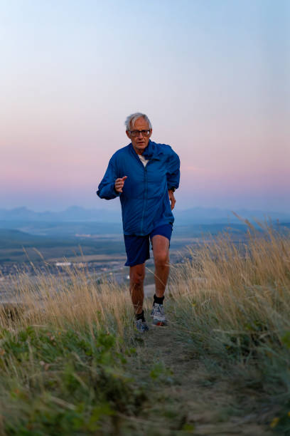 istock Senior man runs through grasses at sunset 2170589546