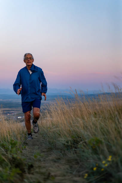 istock Senior man runs through grasses at sunset 2170589642