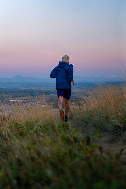 istock Senior man runs through grasses at sunset 2170589644