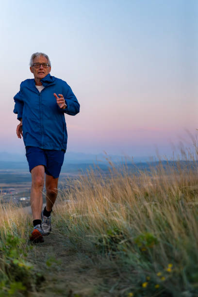 istock Senior man runs through grasses at sunset 2170589646