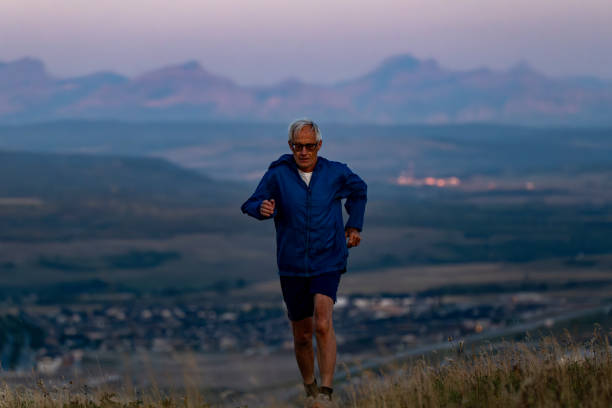 istock Senior man runs through grasses at sunset 2170589789