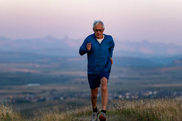 istock Senior man runs through grasses at sunset 2170589802
