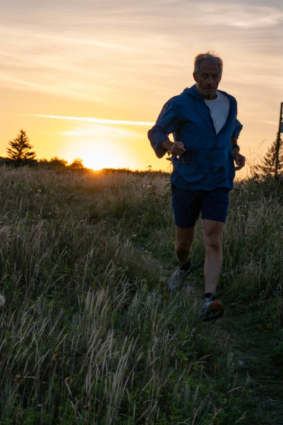 istock Senior man runs through grasses at sunset 2170589809