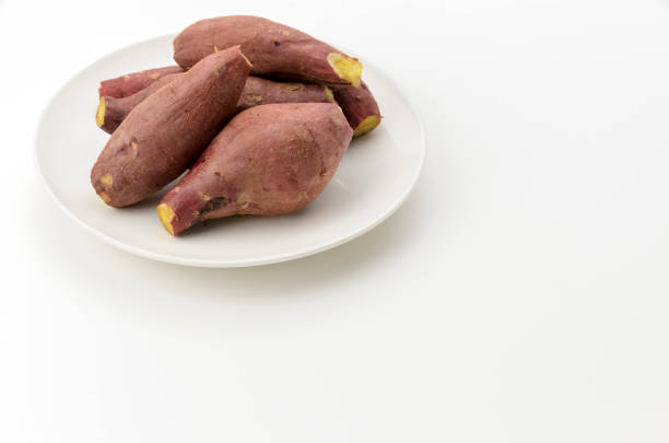 Steamed sweet potatoes on a white plate