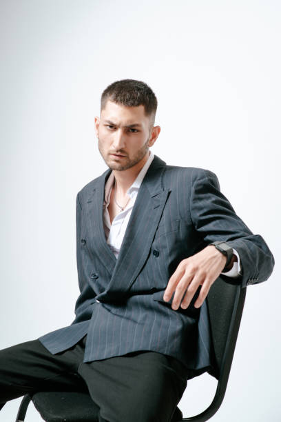 istock Handsome man, fashion model sits on chair 2170592245