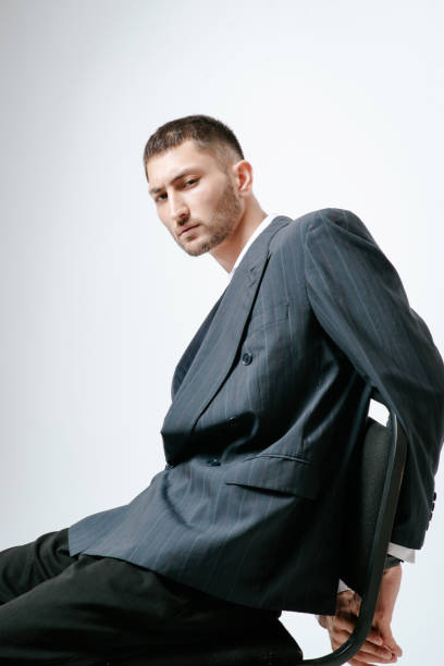 istock Handsome man, fashion model sits on chair 2170592250
