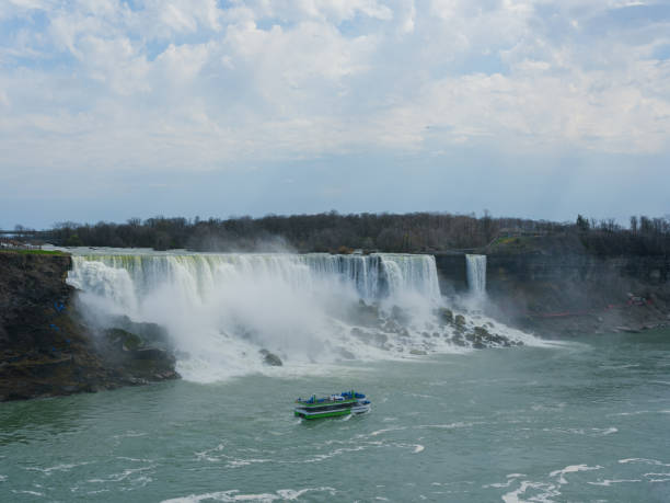 Tourist tour boat at powerful  Niagara Falls in springtime