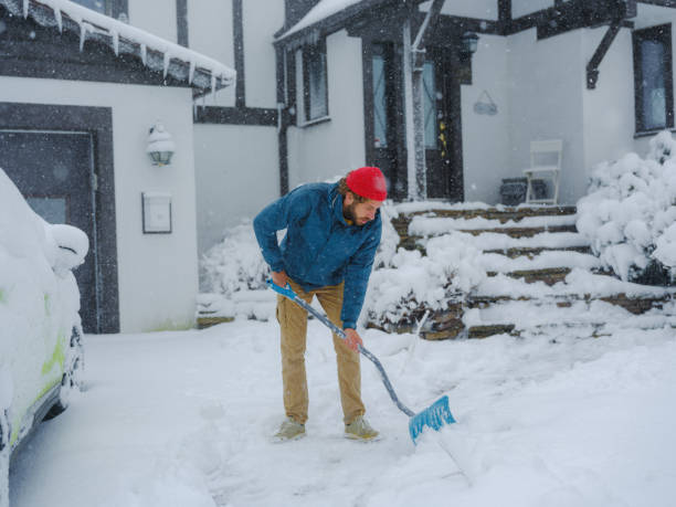 istock Man clearing the snow from walkway in suburbs 2170593200