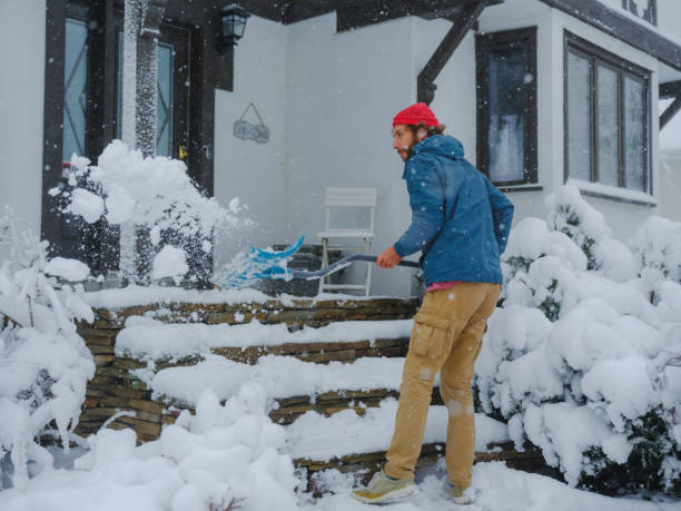 istock Man clearing the snow from walkway in suburbs 2170593228