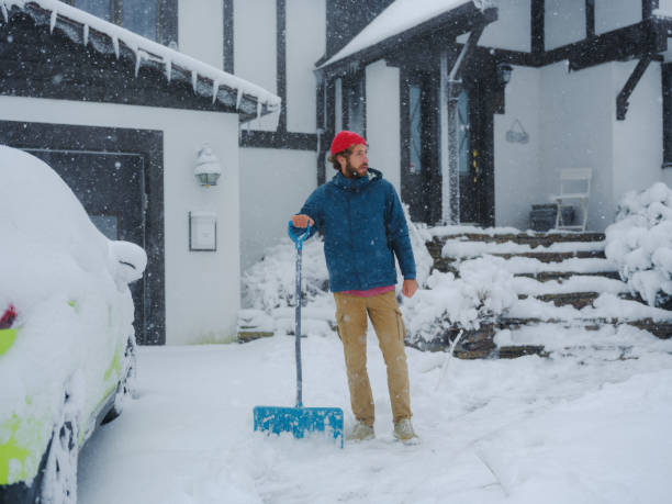 istock Man clearing the snow from walkway in suburbs 2170593234
