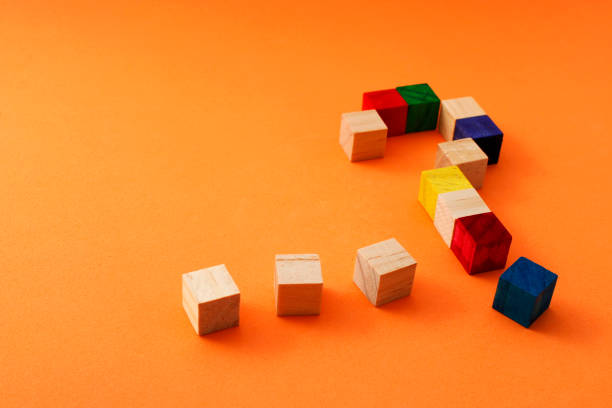 istock Ellipsis and question mark formed with wooden cubes 2170594925