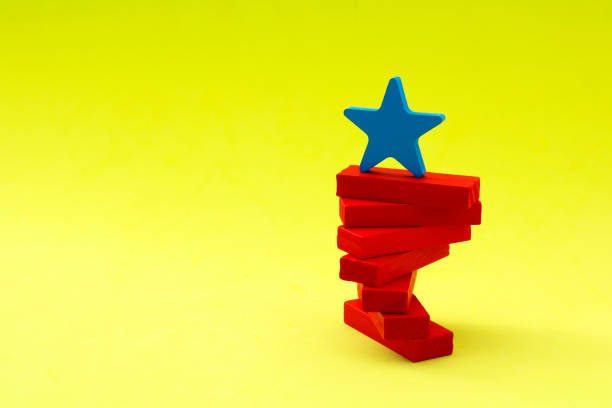 istock Star leader staying balanced on wooden figures that rotate on an axis 2170595023