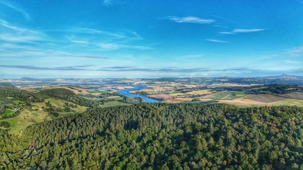 Aerial photograph of a Perthshire landscape from Kinnoull Hill including Kinnoull forest the river Tay and rolling green countryside and clear blue summer skies
