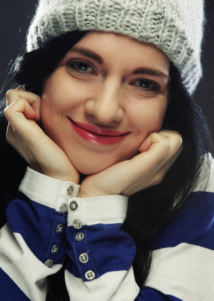 Playful young woman in funny winter hat