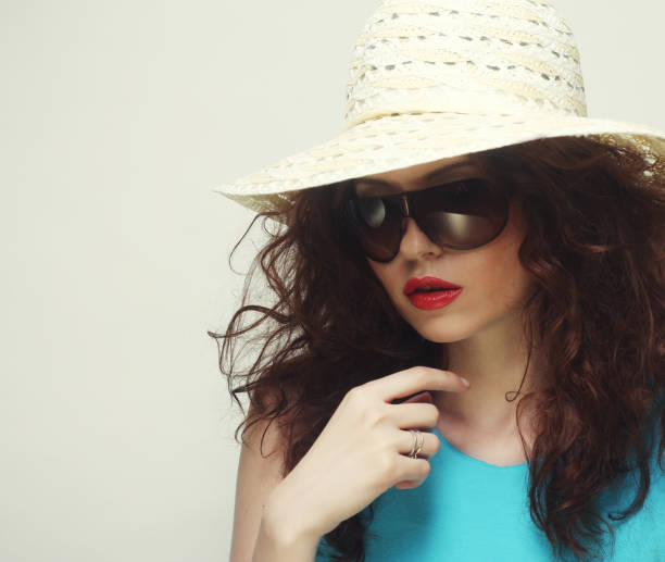 istock young surprised woman wearing hat and sunglasses 2170597538