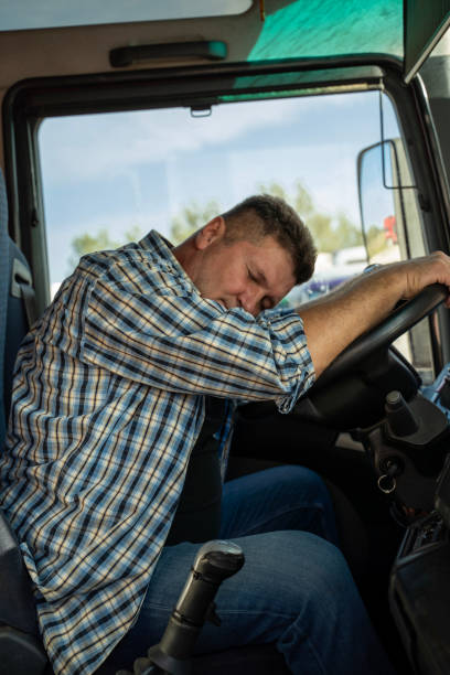 istock Tired truck driver sleeping on the wheel 2170598484