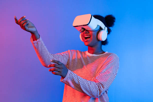 istock Smiling African wearing VR smelling good through meta flower. Contrivance. 2170600699
