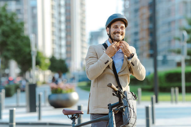 istock Smiling man with a helmet prepares for urban bicycle ride 2170603122
