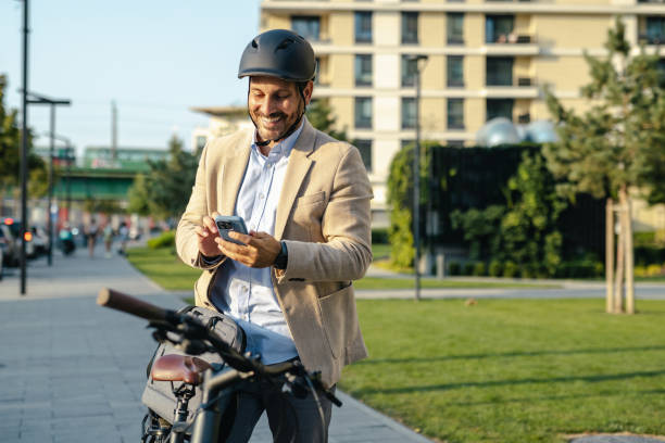 istock Businessman using smartphone while commuting on bicycle in city. Modern sustainable commuting 2170603345