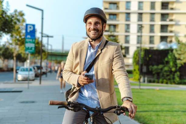 istock Businessman using smartphone while commuting on bicycle in city. Modern sustainable commuting 2170603414