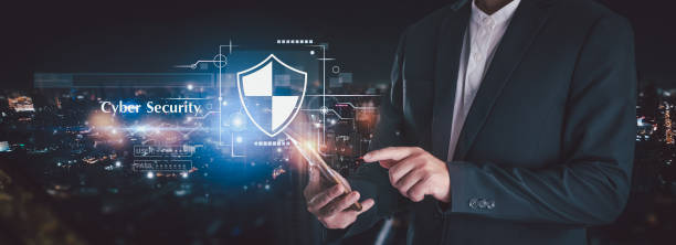 istock A businessman in a suit points at a mobile phone, with a cybersecurity graph floating in the air and tall buildings in the background. This concept emphasizes safe finance and investment. 2170605273