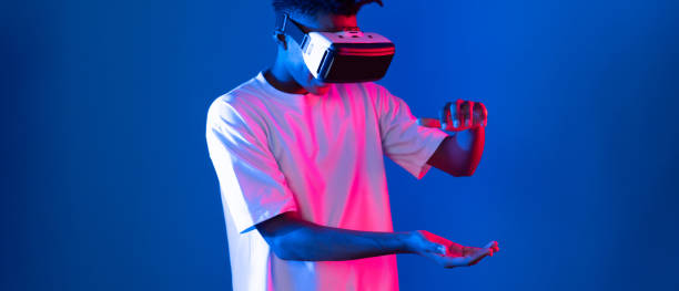 istock Surprised African looking VR holding object hologram neon wall. Contrivance. 2170606424