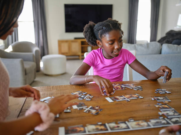 istock Family in a Home Working on a Jigsaw Puzzle 2170609168
