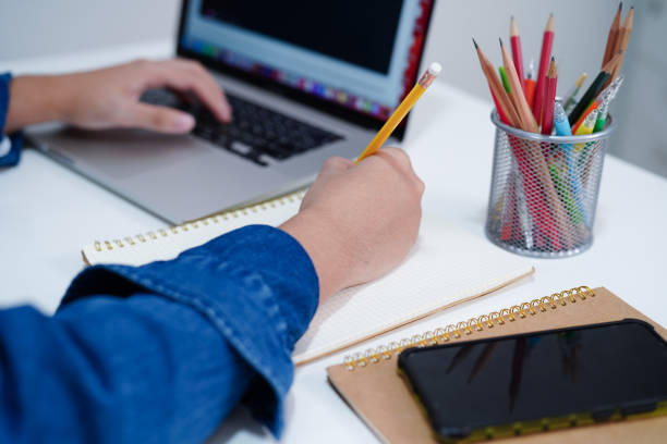 istock Asian teenage student write homework with laptop computer, learning university education concept. 2170615923