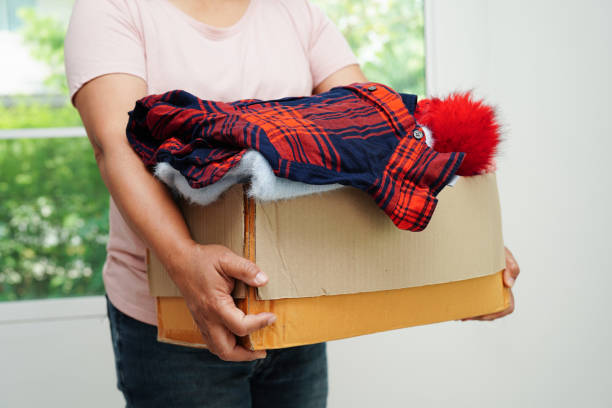 istock Clothes donations in cardboard box for volunteer. 2170615946