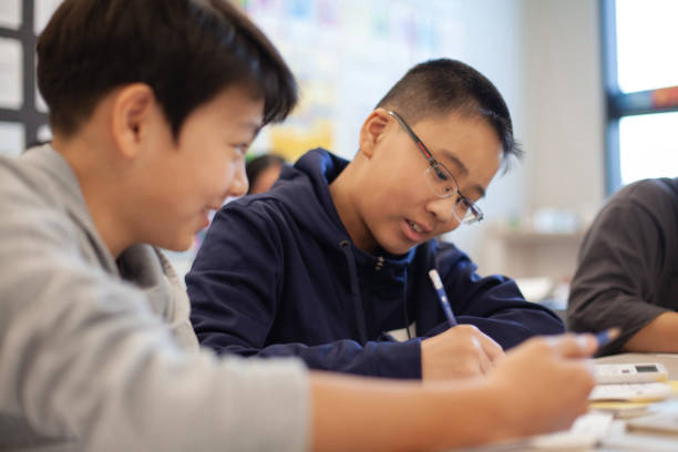 istock Asian Chinese boy studies in elementary school classroom with classmate 2170616033