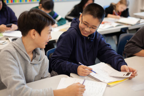 istock Asian Chinese boy studies in elementary school classroom with classmate 2170616116
