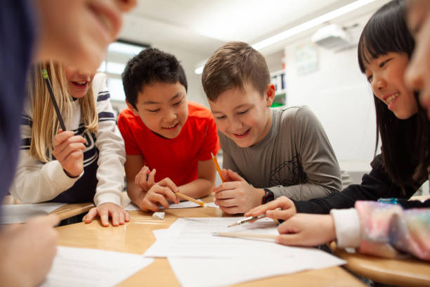 istock Group of multiracial elementary school students talk and enjoy studying together in a classroom 2170616875
