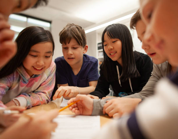 istock Group of multiracial elementary school students talk and enjoy studying together in a classroom 2170616905