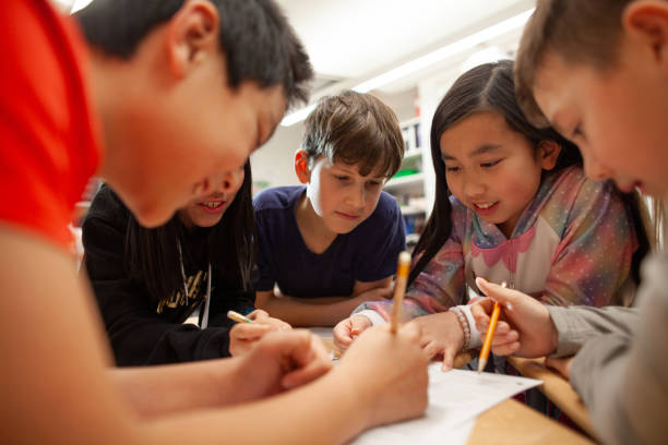 istock Group of multiracial elementary school students talk and enjoy studying together in a classroom 2170616916