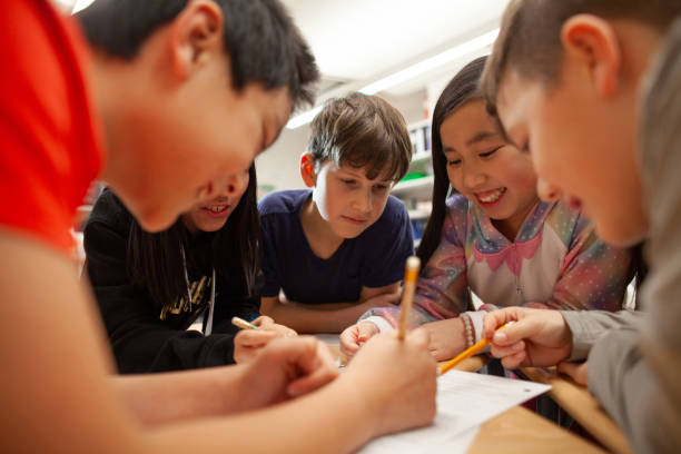 istock Group of multiracial elementary school students talk and enjoy studying together in a classroom 2170616925
